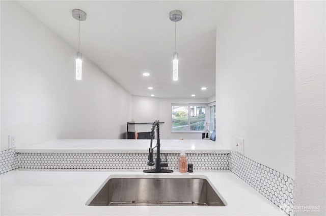 details with recessed lighting, light countertops, a sink, and decorative light fixtures