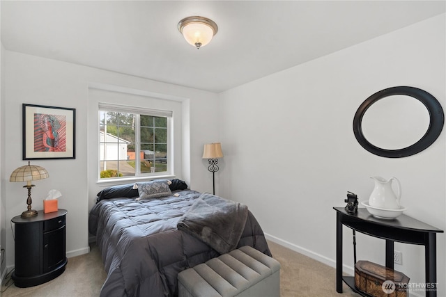 bedroom featuring light carpet and baseboards