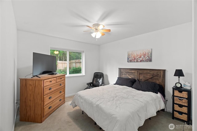 bedroom featuring light colored carpet and ceiling fan