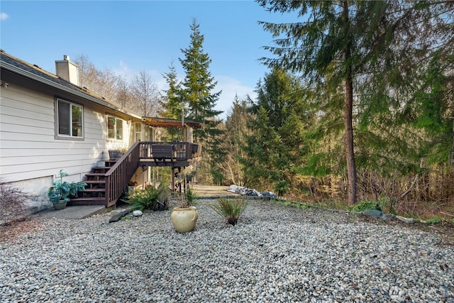 view of yard featuring a deck and stairway