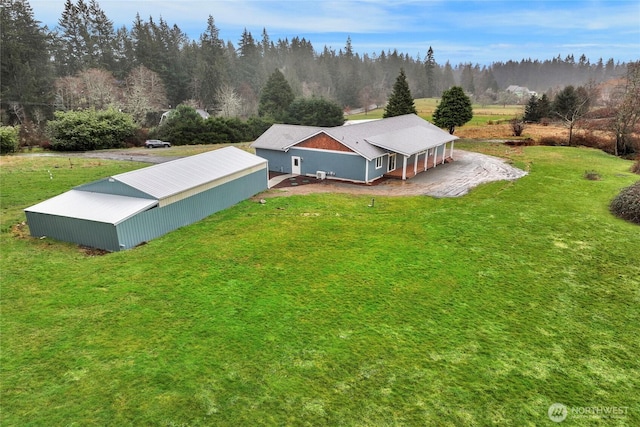 birds eye view of property with a view of trees