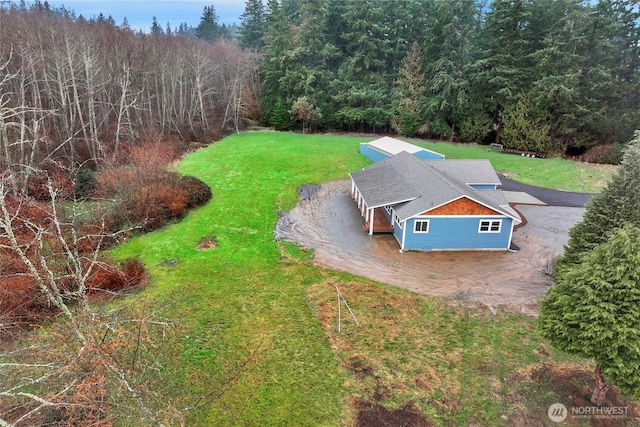 drone / aerial view featuring a view of trees