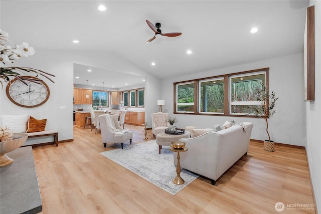 living area featuring a ceiling fan, lofted ceiling, light wood finished floors, and recessed lighting