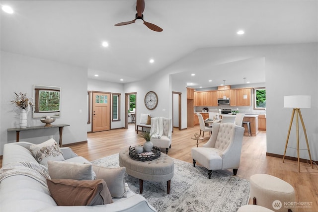 living area featuring vaulted ceiling, baseboards, light wood-style flooring, and recessed lighting