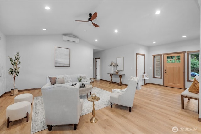 living area with light wood-style floors, recessed lighting, a wall mounted air conditioner, and vaulted ceiling