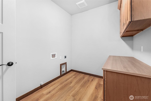 laundry area featuring cabinet space, baseboards, light wood-type flooring, washer hookup, and electric dryer hookup