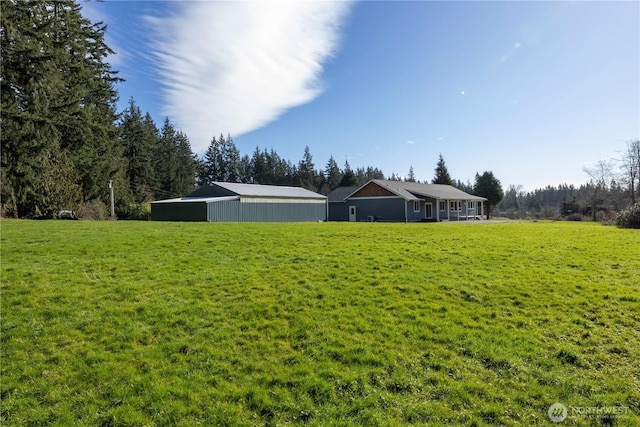 view of yard featuring an outbuilding and a pole building