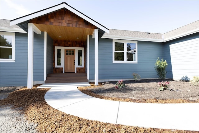 property entrance featuring roof with shingles