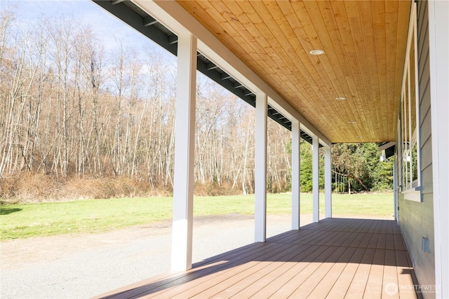 wooden terrace with a lawn