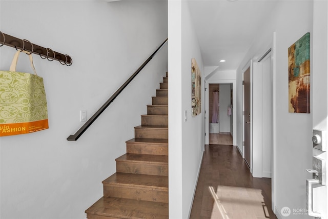 stairway with recessed lighting and wood finished floors