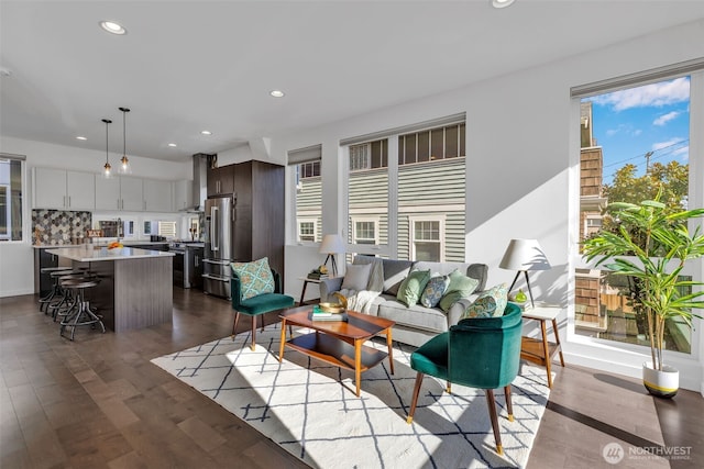 living room with dark wood finished floors and recessed lighting