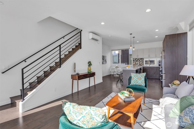 living area featuring recessed lighting, baseboards, stairs, a wall mounted AC, and dark wood-style floors