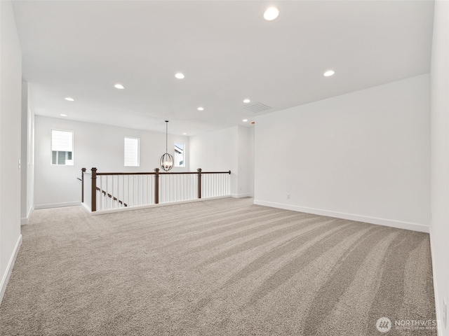 unfurnished room featuring recessed lighting, visible vents, baseboards, and light colored carpet