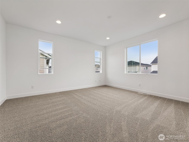 unfurnished room with carpet floors, baseboards, and recessed lighting