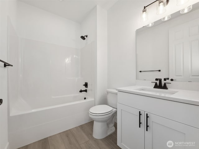 full bathroom with toilet, vanity, wood finished floors, and shower / bathing tub combination