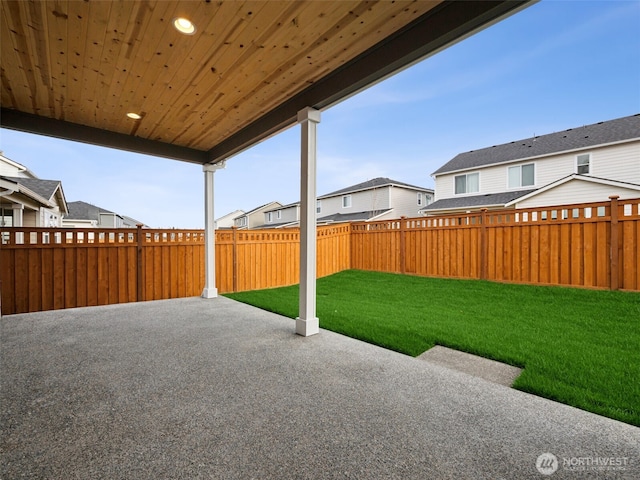 view of patio / terrace featuring a fenced backyard and a residential view