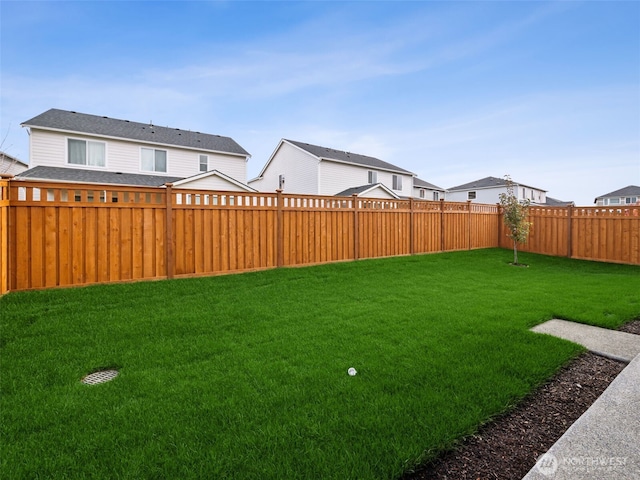 view of yard with a fenced backyard