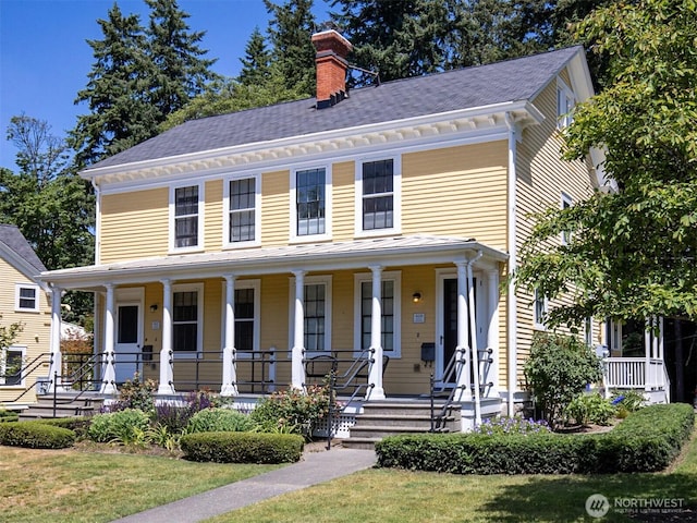 view of front of house with covered porch and a chimney