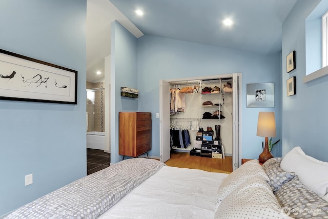 bedroom featuring lofted ceiling, a closet, recessed lighting, a spacious closet, and ensuite bathroom