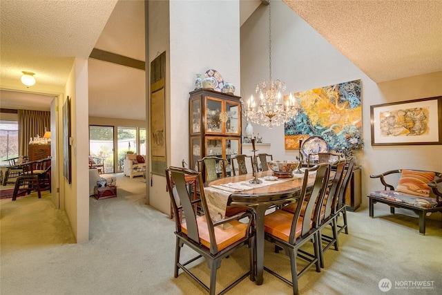 dining space with light carpet, a high ceiling, a chandelier, and a textured ceiling