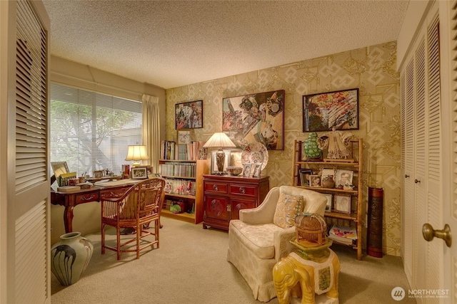 living area with carpet floors, wallpapered walls, and a textured ceiling