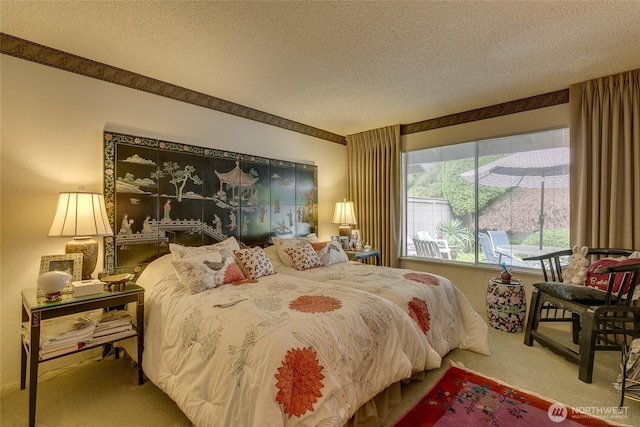 bedroom with carpet and a textured ceiling