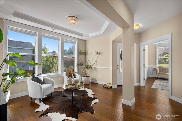 sitting room featuring a tray ceiling, visible vents, crown molding, and hardwood / wood-style flooring