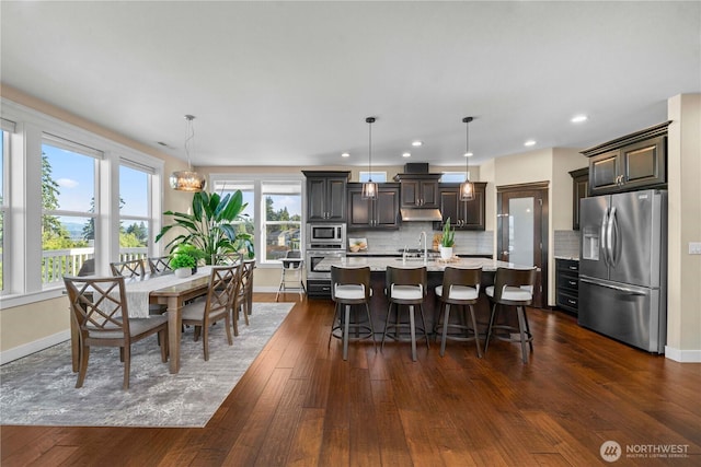 dining area with baseboards, dark wood finished floors, a notable chandelier, and recessed lighting