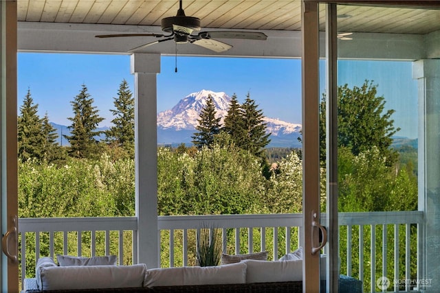 exterior space with ceiling fan and a mountain view