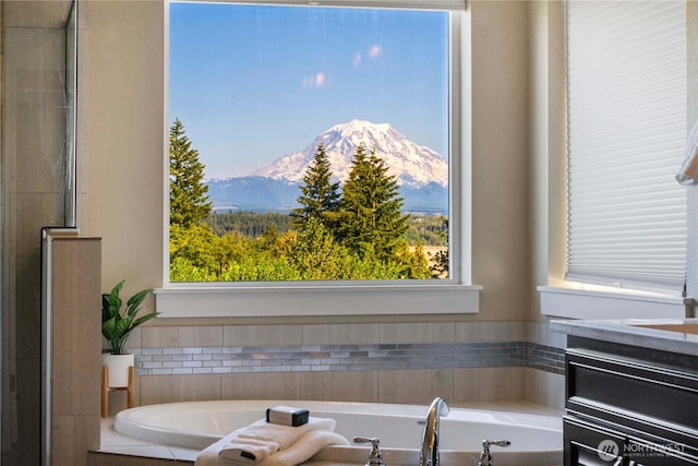 full bathroom with a mountain view and a bath