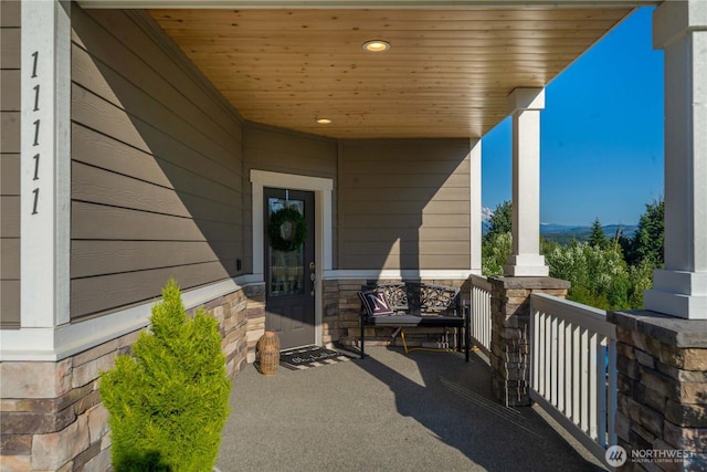 view of exterior entry featuring a porch