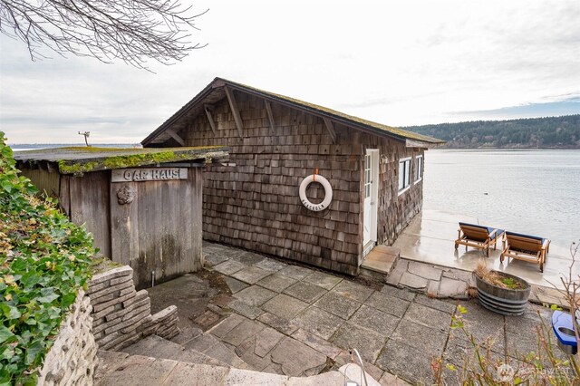 view of outbuilding with a water view