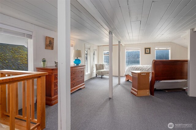 carpeted bedroom featuring lofted ceiling and wood ceiling