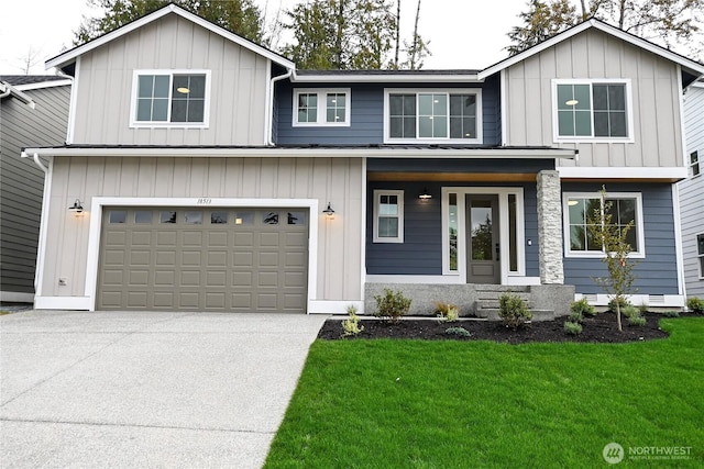 view of front of home featuring a garage, concrete driveway, a front lawn, and board and batten siding