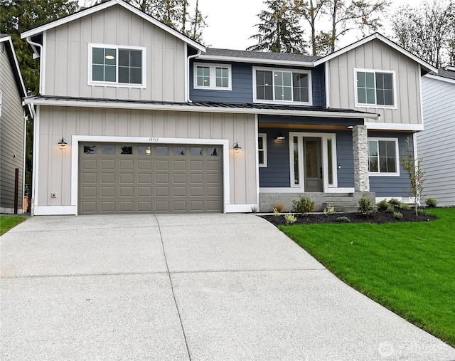 view of front of home featuring an attached garage, board and batten siding, a standing seam roof, driveway, and a front lawn