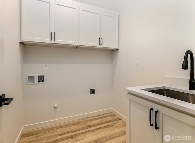 laundry room featuring light wood finished floors, baseboards, hookup for an electric dryer, washer hookup, and a sink