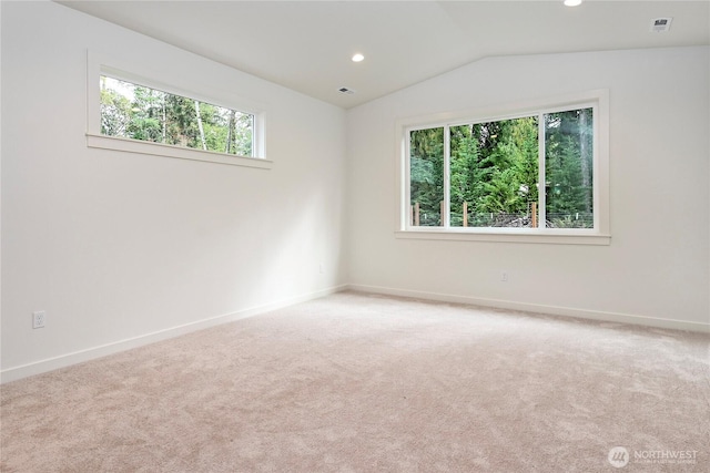 carpeted spare room featuring recessed lighting, visible vents, vaulted ceiling, and baseboards