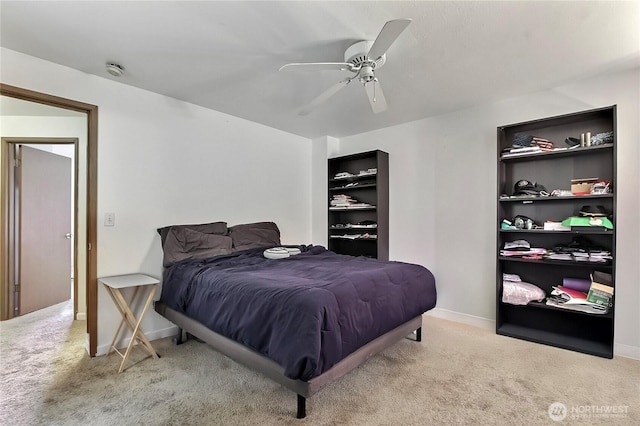 carpeted bedroom featuring baseboards and a ceiling fan