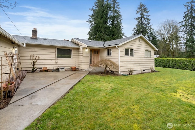 back of house featuring roof with shingles, a yard, a chimney, a patio, and crawl space