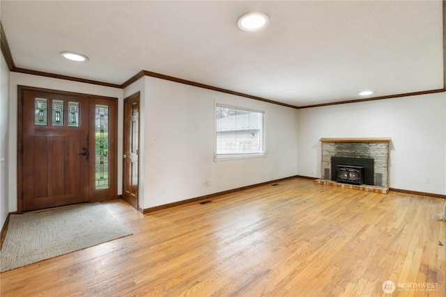 foyer entrance with crown molding, light wood-type flooring, and baseboards