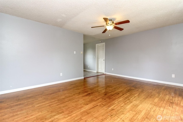 17123 6th Avenue Ct E, Spanaway, WA 98387 - spare room featuring a ceiling fan, wood-type flooring, baseboards, and a textured ceiling