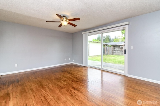 17123 6th Avenue Ct E, Spanaway, WA 98387 - unfurnished room with a ceiling fan, baseboards, wood-type flooring, and a textured ceiling
