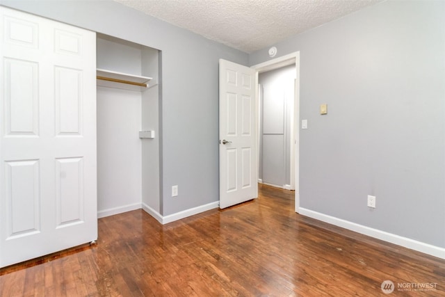 17123 6th Avenue Ct E, Spanaway, WA 98387 - unfurnished bedroom with wood-type flooring, a closet, baseboards, and a textured ceiling