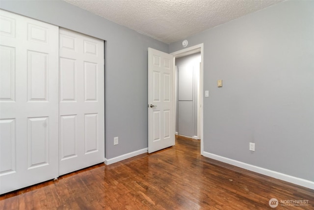 17123 6th Avenue Ct E, Spanaway, WA 98387 - unfurnished bedroom with wood finished floors, baseboards, a textured ceiling, and a closet