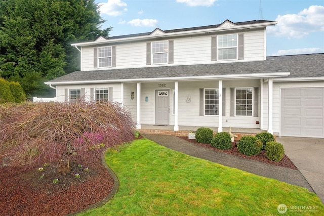 traditional-style home featuring driveway, a shingled roof, a porch, an attached garage, and a front lawn