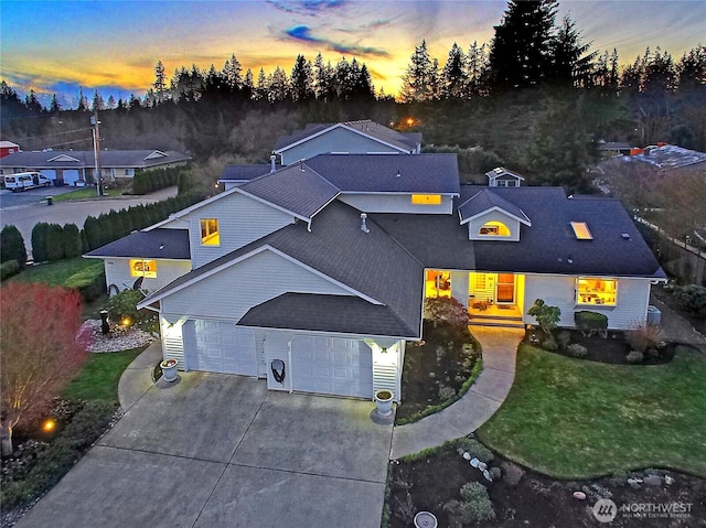 view of front of home featuring a garage, a front yard, and driveway