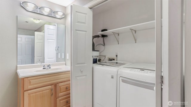 washroom with a sink, laundry area, and washing machine and dryer