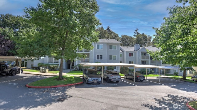 partially covered parking lot featuring a residential view