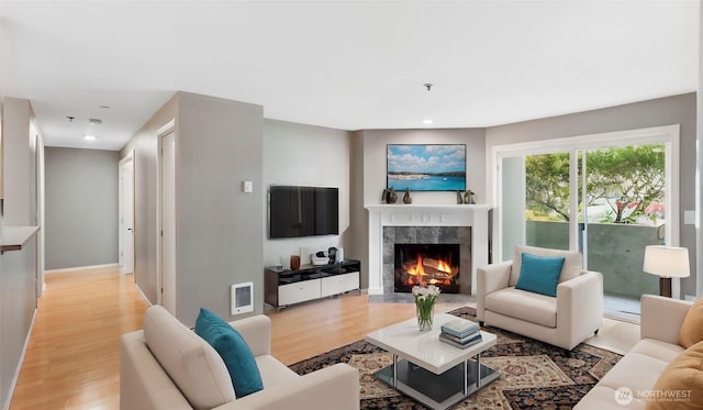 975 Aberdeen Ave NE Unit F204, Renton, WA 98056 - living room with recessed lighting, baseboards, light wood-type flooring, and a premium fireplace