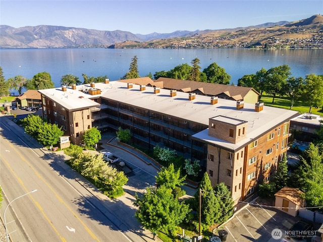 drone / aerial view with a water and mountain view